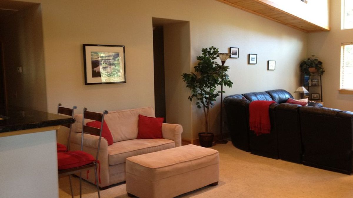 a living room filled with furniture and a flat screen tv