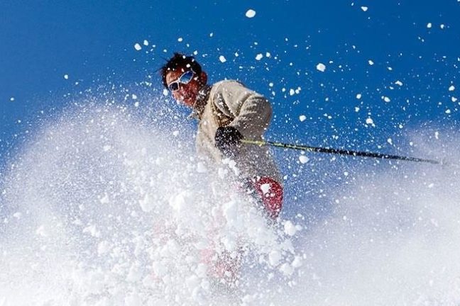 a man flying through the air while riding skis